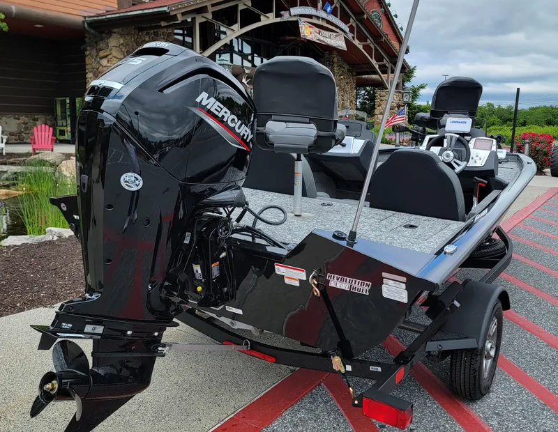 Slide: The Image of 2025 Tracker Pro Team 175 boat with Mercury engine, displayed outdoors. - 2