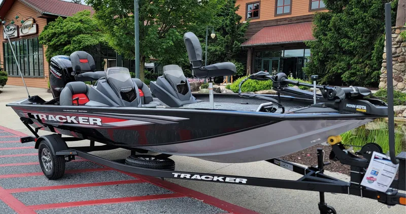 Slide: The Image of 2025 Tracker Pro Team 175 boat on trailer, parked outdoors near a building. - 5