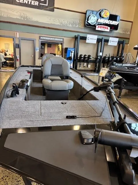 Slide: The Image of 2025 Tracker Panfish 17 boat displayed in showroom with seating and equipment. - 3