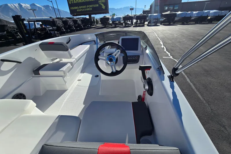 Slide: The Image of 2025 Tahoe T16 boat interior with steering wheel and seating, displayed outdoors. - 15