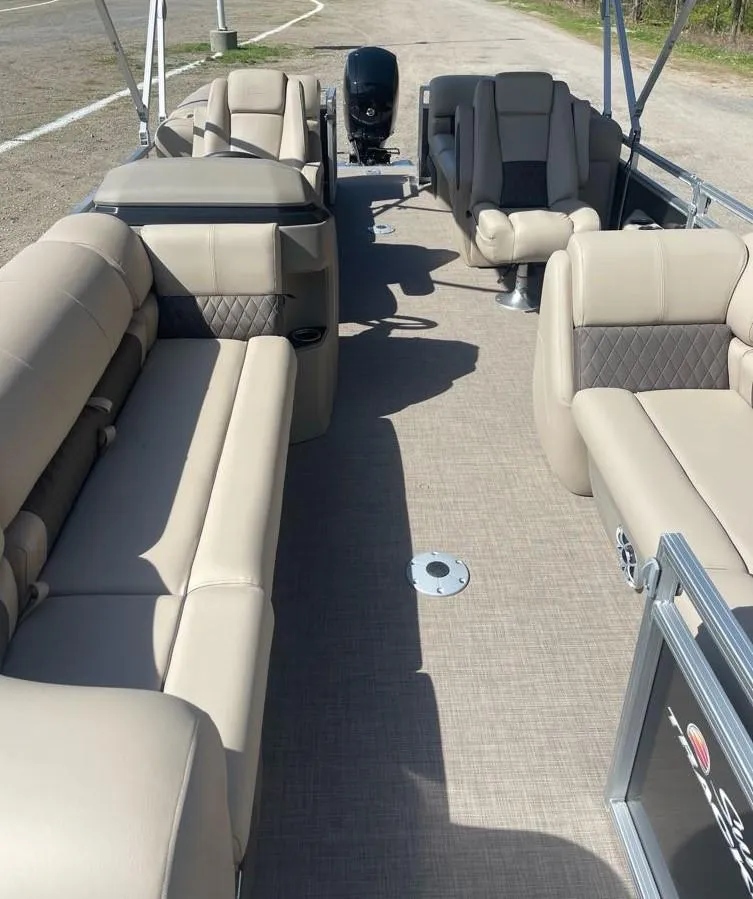Slide: The Image of 2025 Sun Tracker Party Barge 22 DLX interior with beige seating and spacious layout. - 6