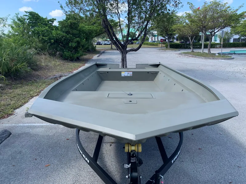 Slide: The Image of 2025 Tracker GRIZZLY 2072 Utility boat on trailer in parking lot. - 2