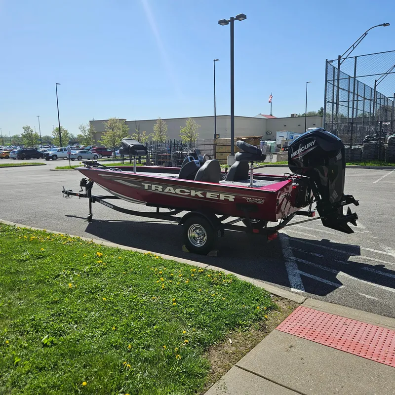 Slide: The Image of 2025 Tracker Pro Team 175 boat on trailer in parking lot, sunny day. - 3