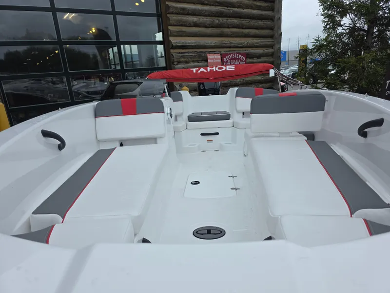 Slide: The Image of 2025 Tahoe T18 boat interior with white and gray seating, red accents, and modern design. - 2