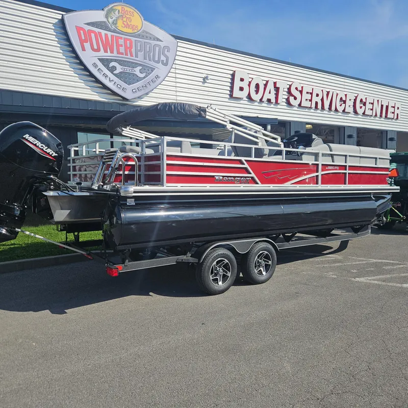Slide: The Image of 2025 Ranger Reata 220FC pontoon boat at a boat service center. - 2
