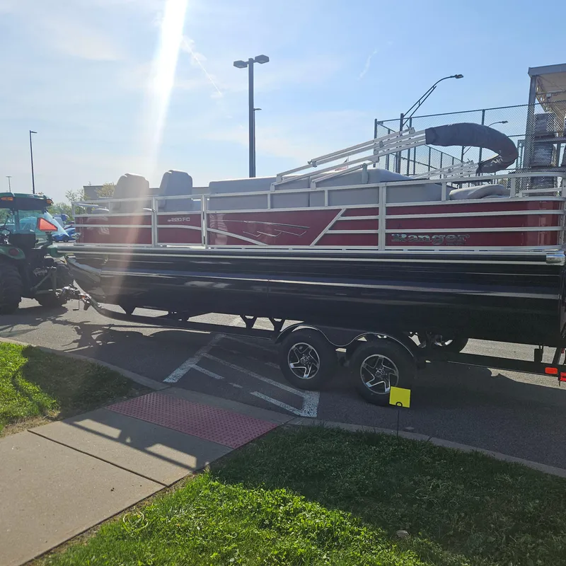 Slide: The Image of 2025 Ranger Reata 220FC pontoon boat on trailer in parking lot. - 4