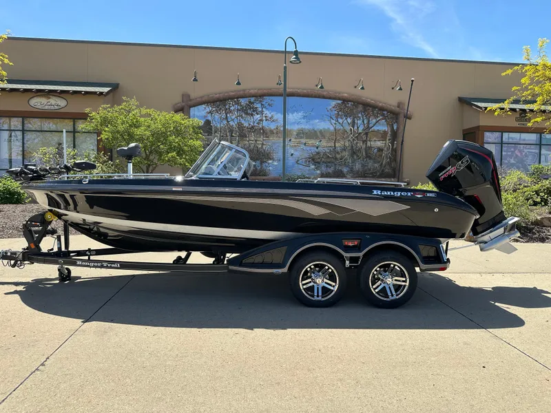 Slide: The Image of 2025 Ranger 620FS Cup Equipped boat on trailer, parked outdoors. - 0