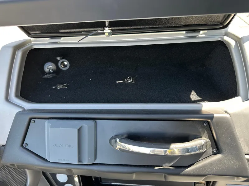 Slide: The Image of 2025 Ranger 620FS Cup Equipped storage compartment with keys and JL Audio panel. - 11