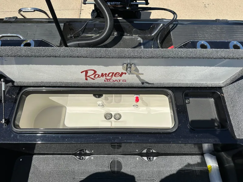 Slide: The Image of 2025 Ranger 620FS Cup Equipped boat interior with storage compartment open. - 22