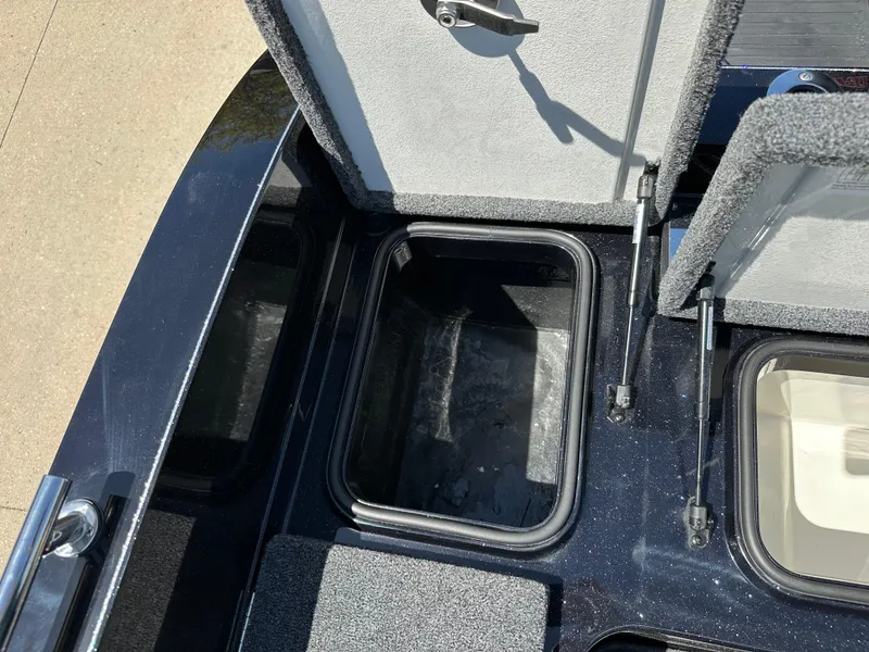 Slide: The Image of 2025 Ranger 620FS Cup Equipped boat storage compartment, open lid, interior view. - 24