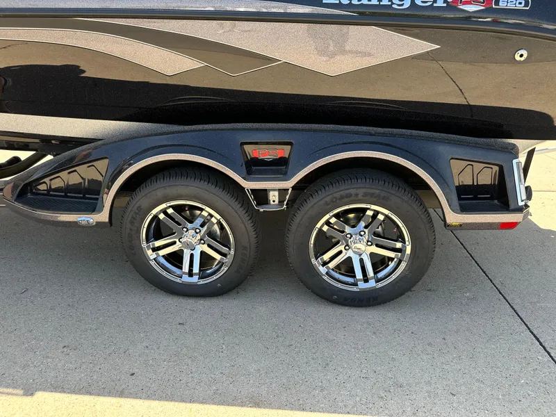 Slide: The Image of 2025 Ranger 620FS Cup Equipped trailer with dual chrome wheels on pavement. - 3