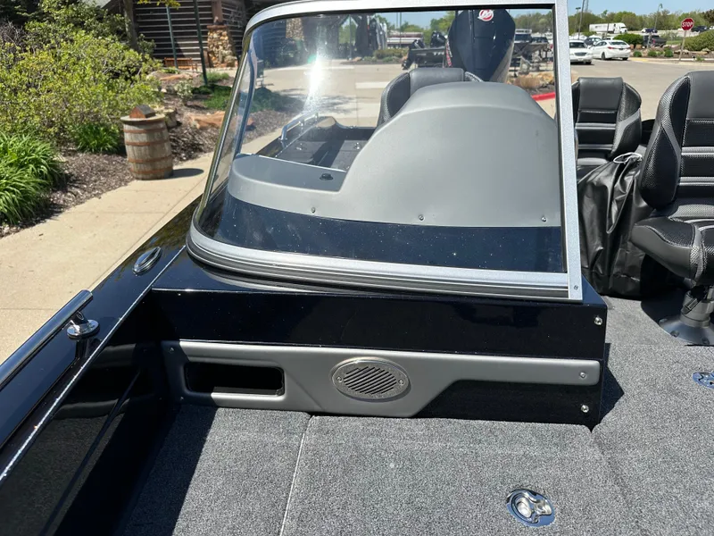 Slide: The Image of 2025 Ranger 620FS Cup Equipped boat interior with windshield and seating, parked outdoors. - 8