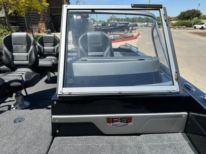 Slide: The Image of 2025 Ranger 620FS Cup Equipped boat with seating and windshield, parked outdoors. - 9