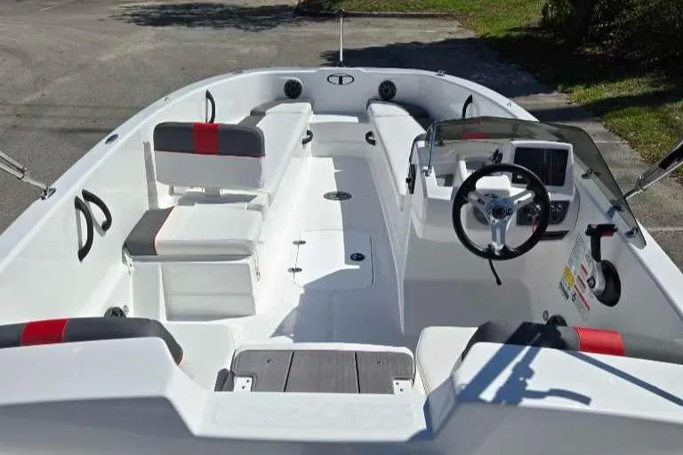 Slide: The Image of 2025 Tahoe T18 boat interior with seating, steering wheel, and dashboard in a sleek design. - 2