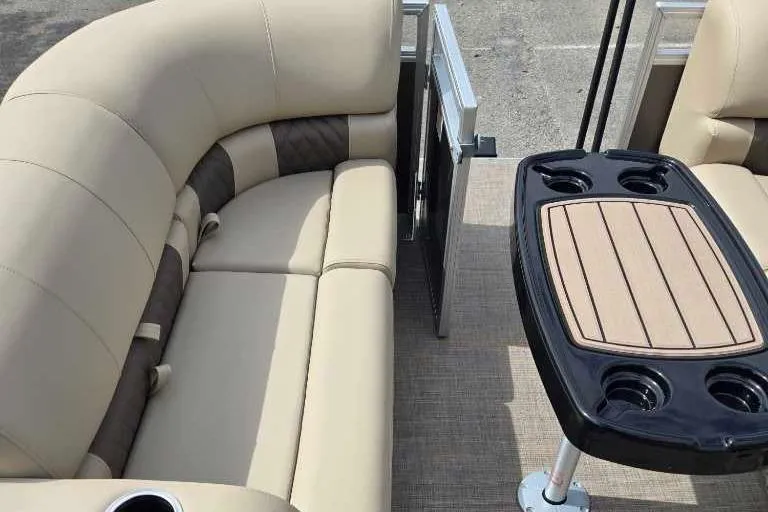 Slide: The Image of 2025 Sun Tracker Party Barge 22 RF DLX interior with beige seating and table. - 4