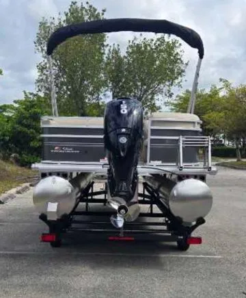 Slide: The Image of 2025 Sun Tracker Party Barge 22 RF DLX pontoon boat in parking lot. - 7