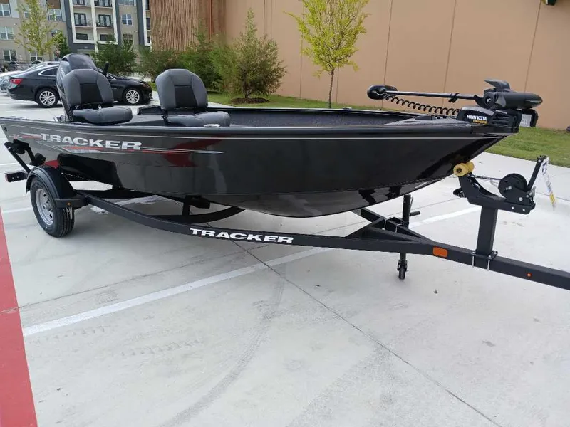 Slide: The Image of 2025 Tracker Super Guide V-16 T boat on trailer in parking lot. - 2