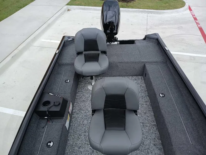 Slide: The Image of 2025 Tracker Super Guide V-16 T boat interior with two gray seats and motor. - 7