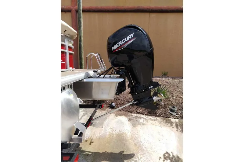 Slide: The Image of 2025 Sun Tracker Party Barge 22 DLX with Mercury outboard motor, rear view. - 70