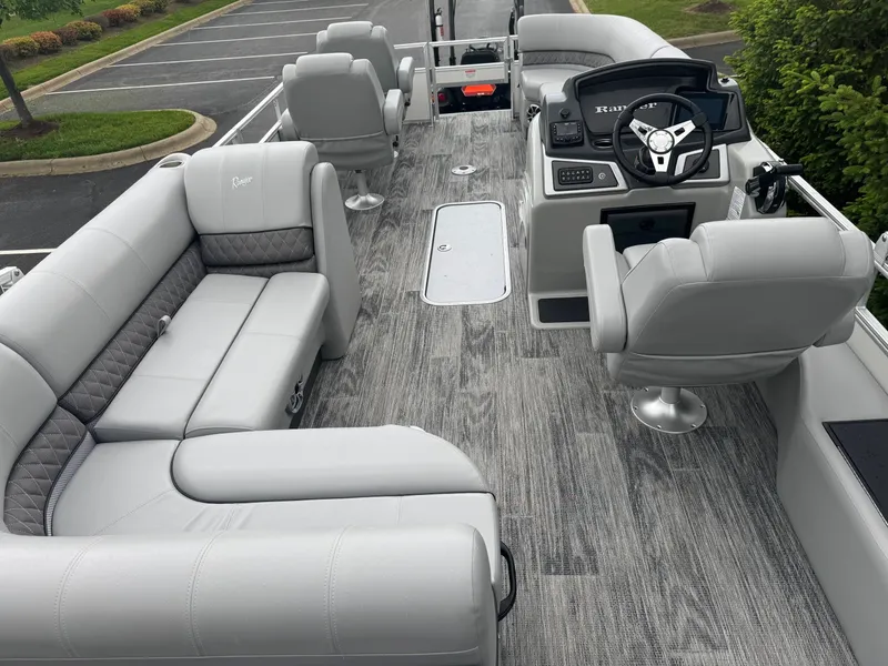 Slide: The Image of 2025 Ranger Reata 223FC boat interior with gray seating and modern helm. - 2