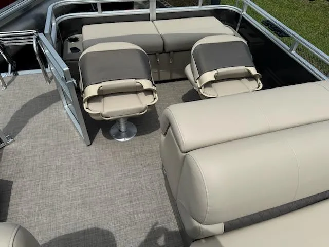 Slide: The Image of 2025 Sun Tracker Fishin' Barge 22 DLX interior with beige seating and open deck layout. - 9