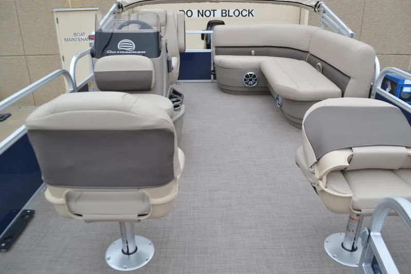 Slide: The Image of 2025 Sun Tracker Bass Buggy 16 XL Select interior with beige seating and spacious layout. - 3