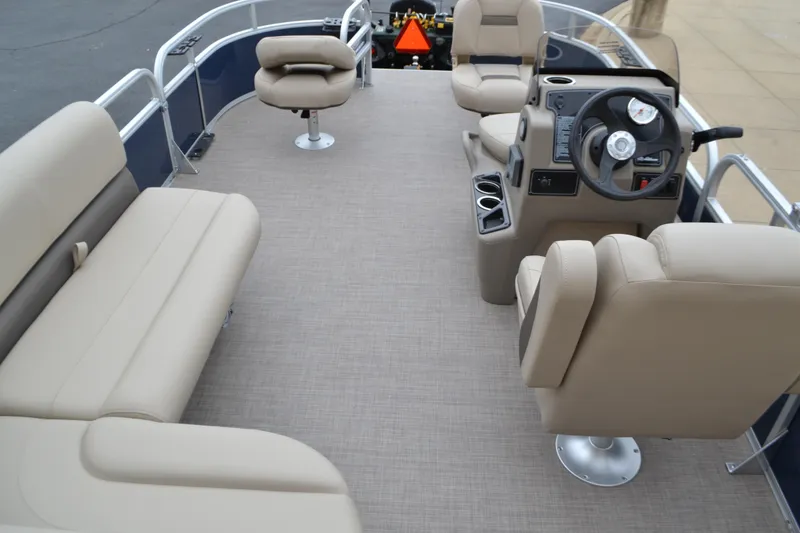 Slide: The Image of 2025 Sun Tracker Bass Buggy 16 XL Select pontoon boat interior with beige seating and steering console. - 4