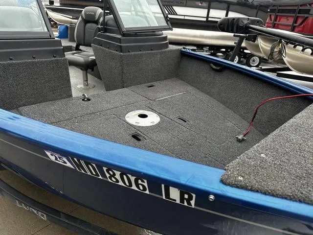 Slide: The Image of 2022 Lund 1650 Rebel XL Sport boat, blue exterior, spacious interior, fishing-ready design. - 10