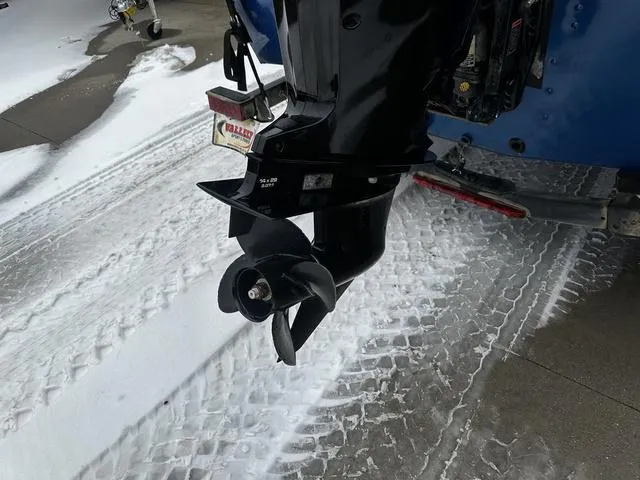 Slide: The Image of 2022 Lund 1650 Rebel XL Sport boat motor on snowy pavement. - 5