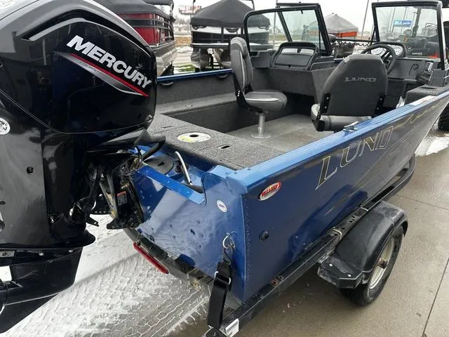 Slide: The Image of 2022 Lund 1650 Rebel XL Sport boat with Mercury engine, blue exterior, on trailer. - 6