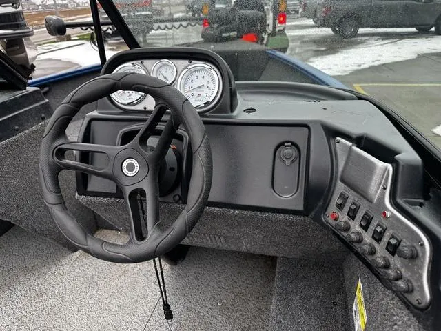 Slide: The Image of 2022 Lund 1650 Rebel XL Sport dashboard with steering wheel and control panel. - 7