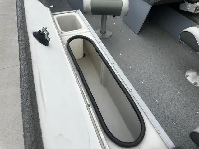 Slide: The Image of 2005 Lund 16 REBEL boat interior with storage compartment and seating. - 11