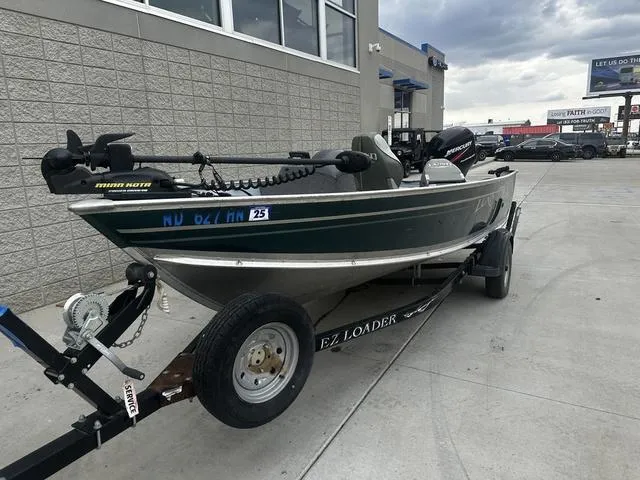 Slide: The Image of 2005 Lund 16 REBEL fishing boat on EZ Loader trailer, parked outdoors. - 3