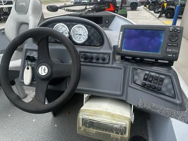 Slide: The Image of 2005 Lund 16 REBEL boat dashboard with steering wheel and Lowrance Elite-7 fish finder. - 8