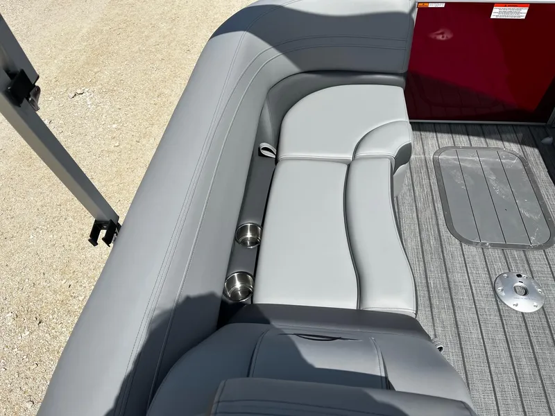 Slide: The Image of Luxurious seating on 2025 SunCatcher Fusion 322RC boat with gray upholstery and cup holders. - 12