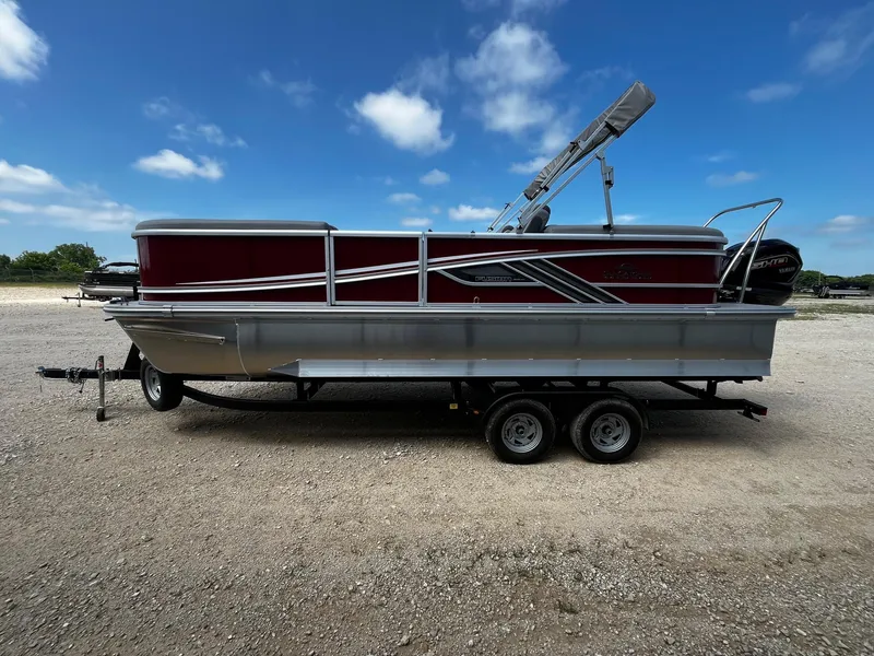 Slide: The Image of 2025 SunCatcher Fusion 322RC pontoon boat on trailer under blue sky. - 4