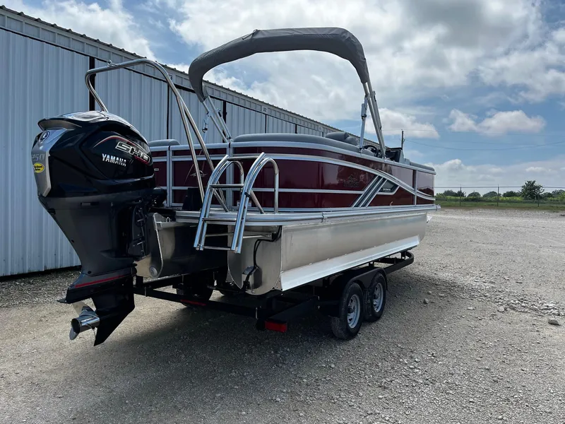 Slide: The Image of 2025 SunCatcher Fusion 322RC pontoon boat with Yamaha engine, parked on a trailer. - 7