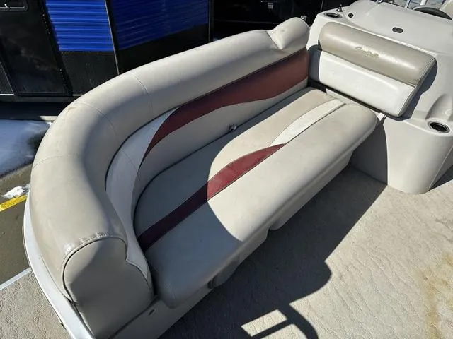 Slide: The Image of 2012 Godfrey Sweetwater boat seating with beige and maroon upholstery, featuring cup holders. - 10