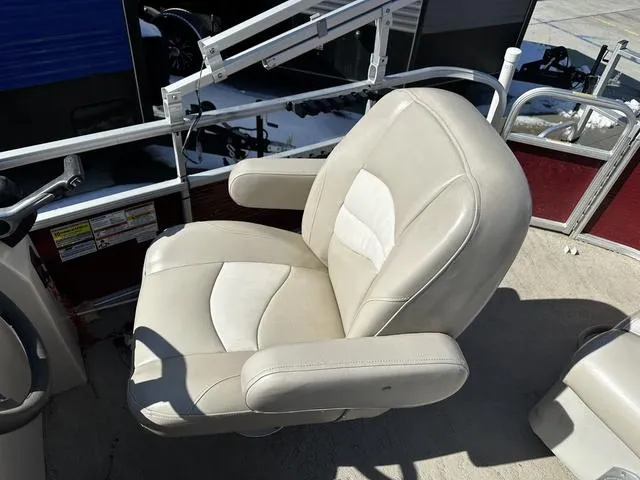 Slide: The Image of Captain's chair on 2012 Godfrey Sweetwater boat, featuring beige upholstery and armrests. - 13