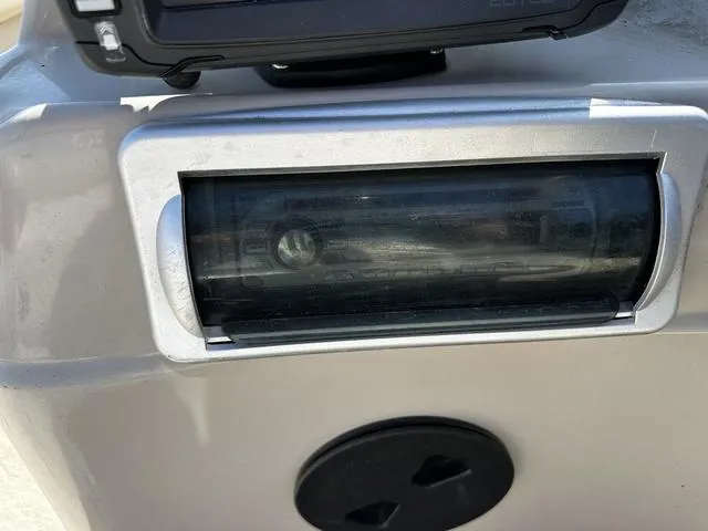 Slide: The Image of Close-up of a 2012 Godfrey Sweetwater boat dashboard with a gauge and control panel. - 16