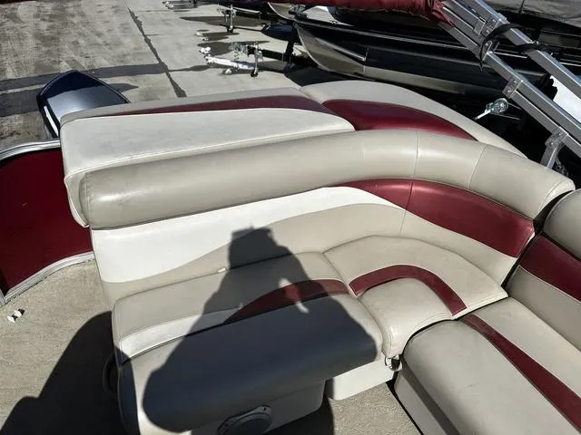 Slide: The Image of 2012 Godfrey Sweetwater boat seating with red and beige upholstery on a sunny day. - 17
