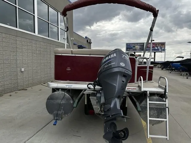 Slide: The Image of 2012 Godfrey Sweetwater pontoon boat with Yamaha motor, parked outdoors under cloudy skies. - 20