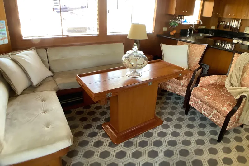 Slide: The Image of Luxurious 1998 Grand Alaskan 60 Pilothouse interior with elegant seating and wooden table. - 11