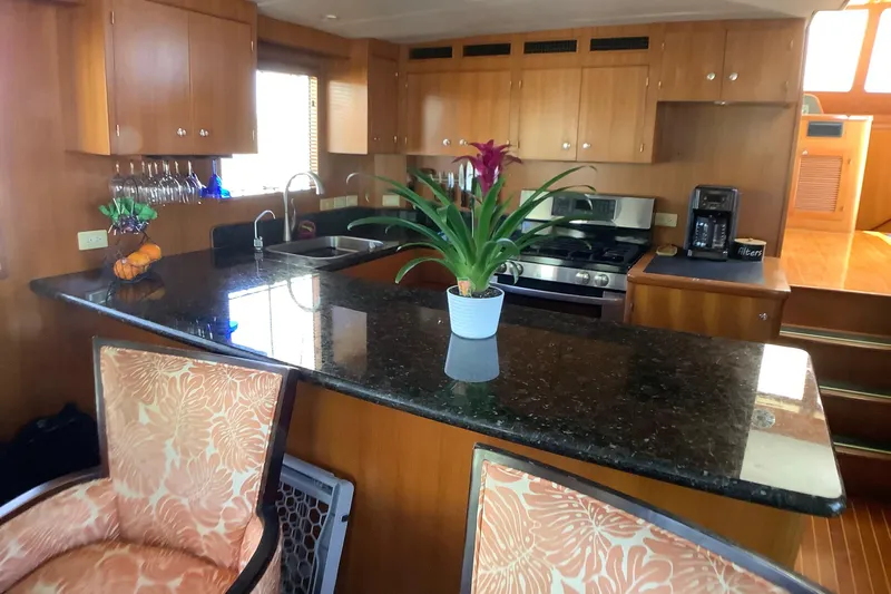 Slide: The Image of Luxurious kitchen interior of 1998 Grand Alaskan 60 Pilothouse yacht with granite countertops. - 15