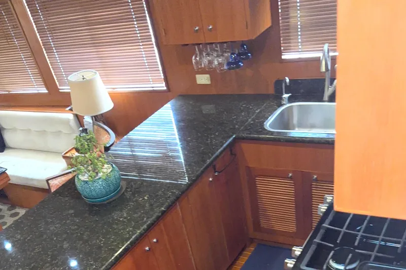 Slide: The Image of Luxurious kitchen interior of 1998 Grand Alaskan 60 Pilothouse yacht with granite countertops. - 17