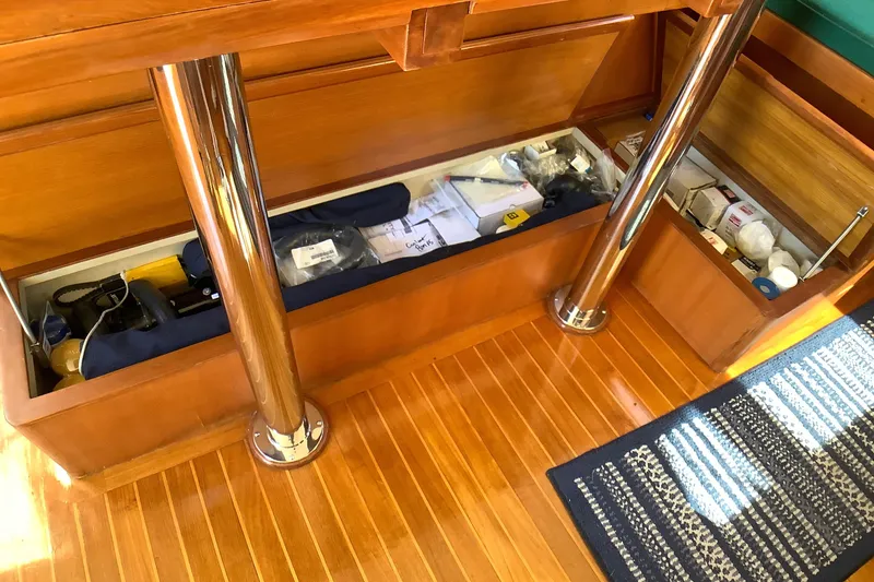 Slide: The Image of Storage compartment on 1998 Grand Alaskan 60 Pilothouse with wooden flooring and metal supports. - 27