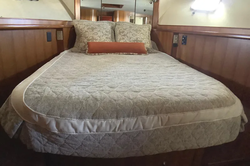 Slide: The Image of Luxurious bedroom interior of 1998 Grand Alaskan 60 Pilothouse yacht with elegant bedding. - 32