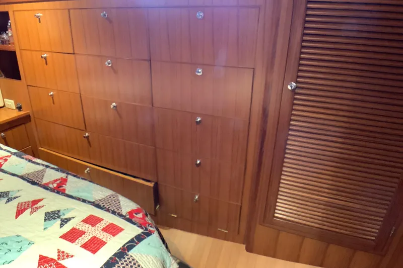 Slide: The Image of Wooden cabin interior of 1998 Grand Alaskan 60 Pilothouse with quilted bedspread. - 34