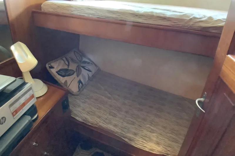 Slide: The Image of Cozy bunk beds in 1998 Grand Alaskan 60 Pilothouse cabin with lamp and pillow. - 35