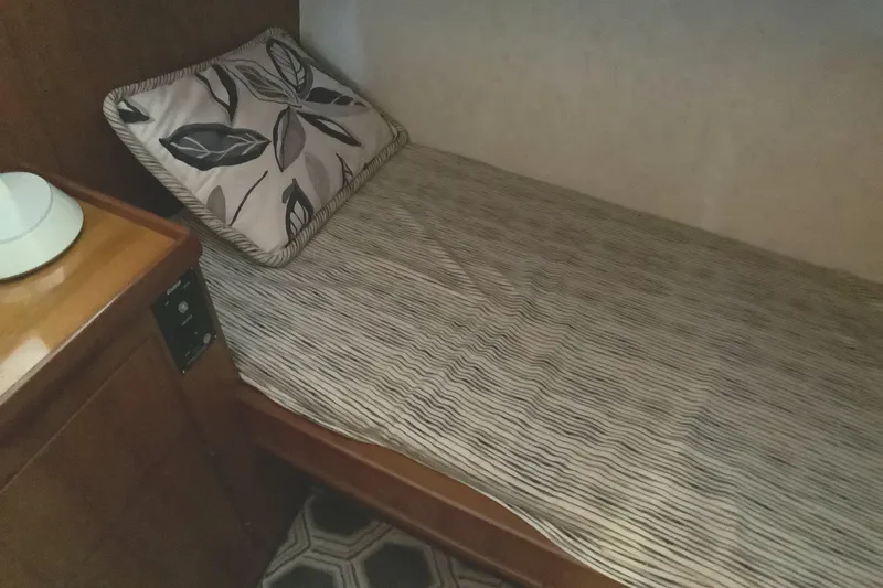 Slide: The Image of Cozy cabin bed in 1998 Grand Alaskan 60 Pilothouse yacht with floral pillow. - 36